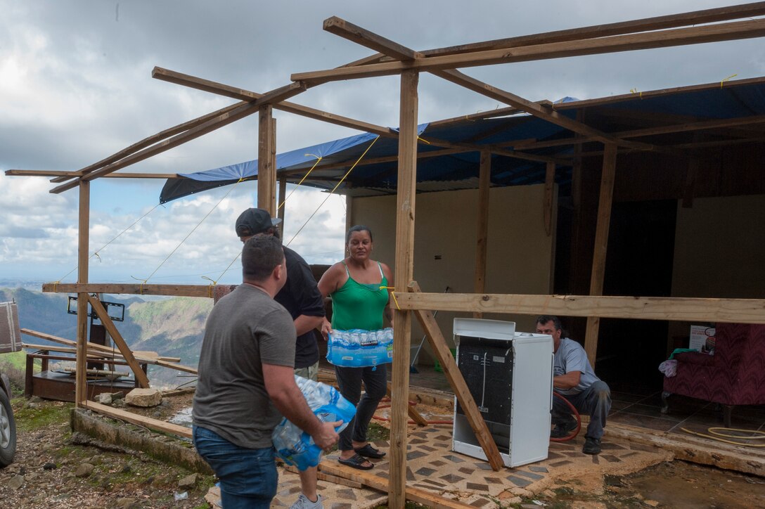 Airmen from the Puerto Rico Air National Guard use their day off to partner with volunteers from the Foundation for Puerto Rico in support of Hurricane Maria relief efforts and load vehicles with food and water for delivery to Orocovis National Guard Army Aviation Facility in San Juan, Puerto Rico, Oct. 13, 2017. Air National Guard photo by Staff Sgt. Michelle Y. Alvarez-Rea