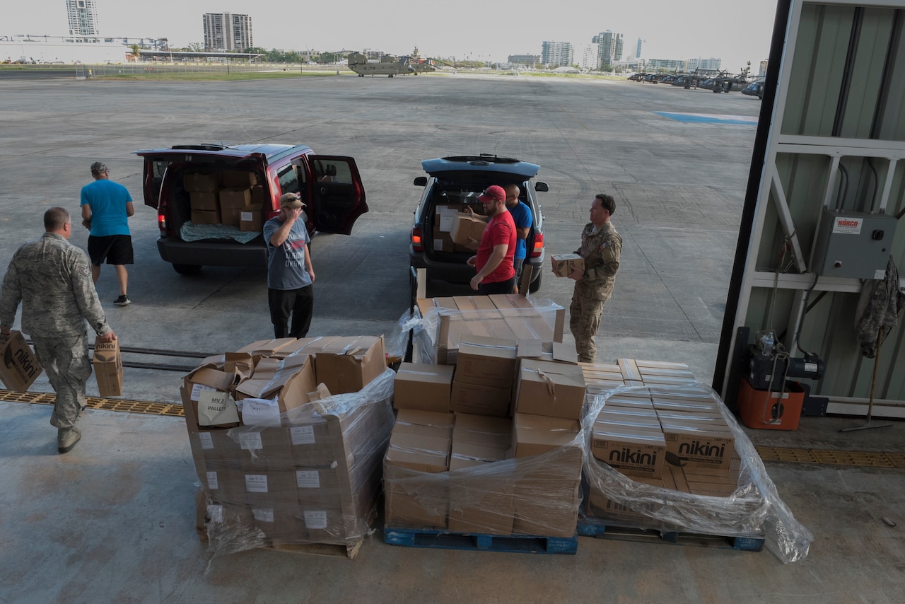 Airmen from the Puerto Rico Air National Guard use their day off to partner with volunteers from the Foundation for Puerto Rico in support of Hurricane Maria relief efforts and load vehicles with food and water for delivery to Orocovis National Guard Army Aviation Facility in San Juan, Puerto Rico, Oct. 13, 2017. Air National Guard photo by Staff Sgt. Michelle Y. Alvarez-Rea