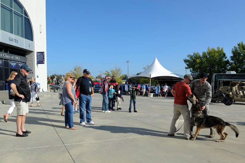 Staff Sgt. Sean Schoonover, right, and Staff Sgt. Adam Dye, left, 628th Security Forces Squadron military working dog handlers, demonstrate military working dog Szultan’s skills to members of the Charleston community at the Johnson Hagood Memorial Stadium for the Citadel’s Military Appreciation Night, Oct. 14, 2017. Members of the 628th Civil Engineer Squadron Explosive Ordnance Disposal Flight and 437th Airlift Wing represented Joint Base Charleston at the football game. Additionally, the Citadel hosted women’s soccer and volleyball games in support of their Military Appreciation Week. The Citadel Bulldog’s football game against the Wofford was the capstone event, with Woffard Terriers winning 20-16.