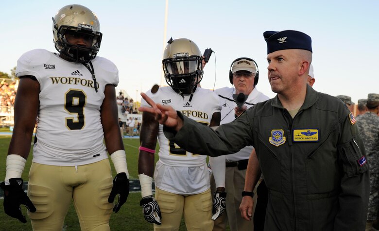 Col. Patrick Winstead, 437th Airlift Wing vice commander, tosses a coin as an honorary captain to determine which team gets possession of the ball at the Johnson Hagood Memorial Stadium for the Citadel’s Military Appreciation Night, Oct. 14, 2017. The 628th Security Forces Squadron and 628th Civil Engineer Squadron Explosive Ordnance Disposal Flight represented Joint Base Charleston at the football game. Additionally, the Citadel hosted women’s soccer and volleyball games in support of Military Appreciation Week. The Citadel Bulldog’s football game against the Wofford Terriers was the capstone event, with Woffard winning 20-16.