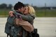 A 492nd Fighter Squadron member greets his wife after returning from a deployment, Oct. 4. F-15E Strike Eagles and Airmen from the 492nd Fighter Squadron and supporting units across the 48th Fighter Wing returned from a six-month deployment to an undisclosed location in Southwest Asia. (U.S. Air Force photo/Airman 1st Class Eli Chevalier)