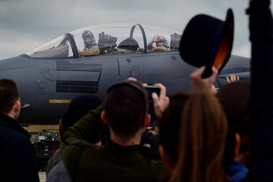 Airmen and families await the return of the 492nd Fighter Squadron at Royal Air Force Lakenheath, England, Oct. 9. F-15E Strike Eagles and Airmen from the 492nd Fighter Squadron and supporting units across the 48th Fighter Wing returned from a six-month deployment to an undisclosed location in Southwest Asia. (U.S. Air Force photo/Tech. Sgt. Matthew Plew)