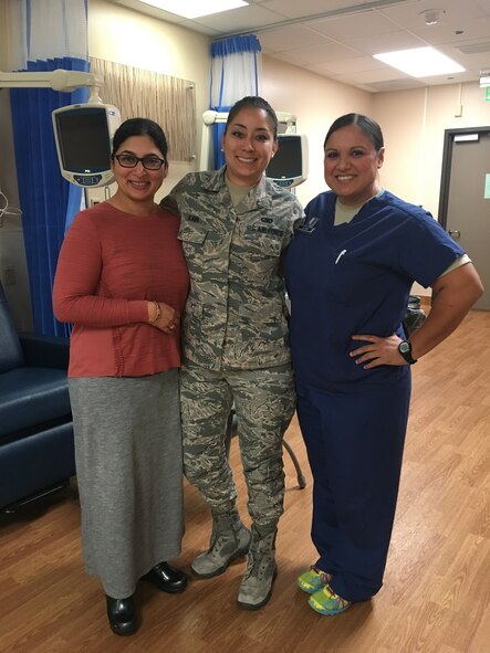 Staff Sergeant Cinnamon Kava (center), 60th Logistics Readiness Squadron unit training manager, poses for a photo Oct. 4 with Dr. Sareena Malhi (left), 60th Medical Operations Squadron physician and Capt. Kendra Alanis (right), 60th MDOS clinical nurse at David Grant USAF Medical Center Oncology unit. Malhi and Alanis were Kava's medical support system during her chemotherapy treatment. (U.S. Air Force photo by Senior Airman Amber Carter)