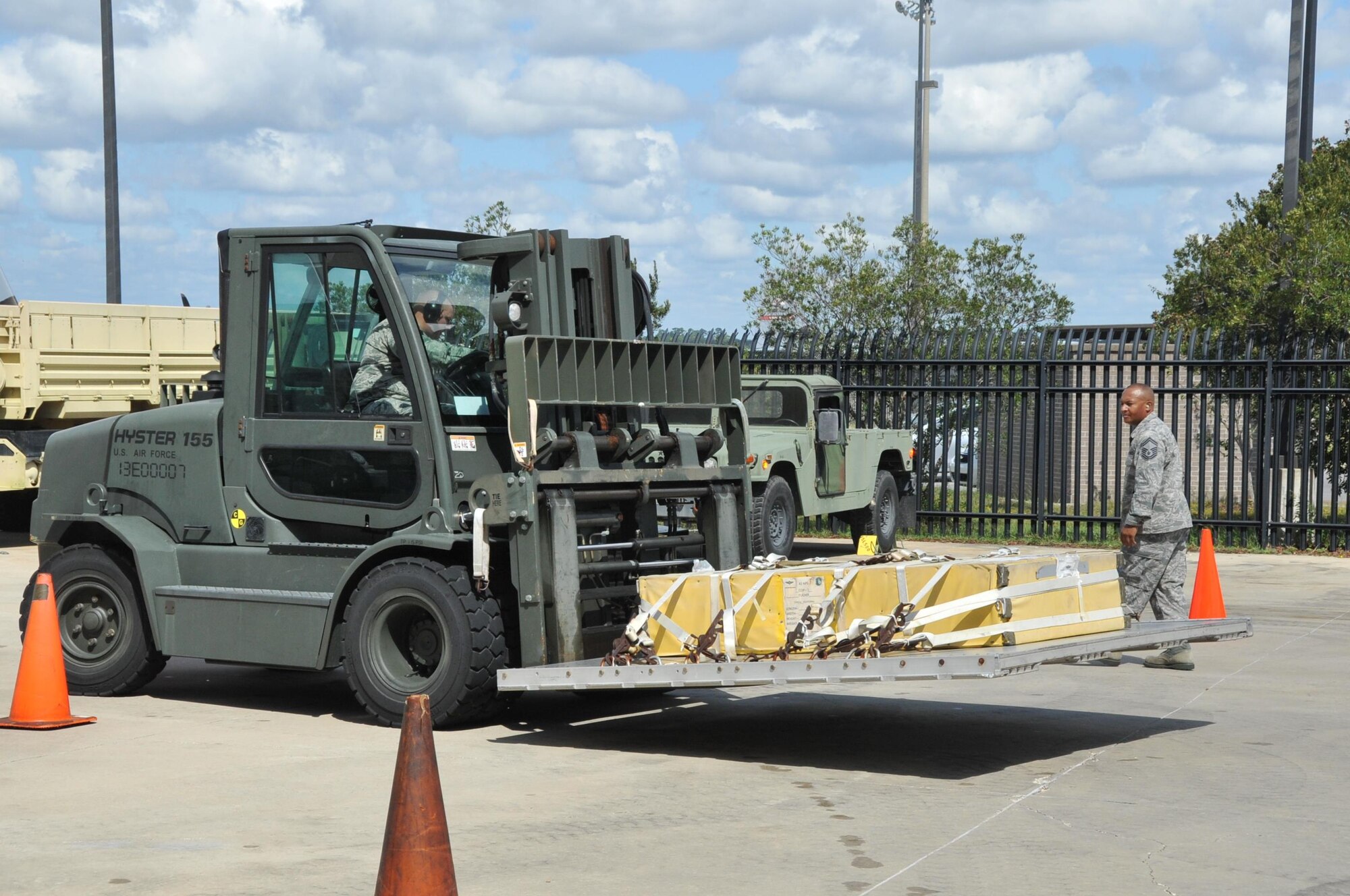 Members of Team Gaston, 41st Aerial Port Squadron air transportation craftsmen Senior Master Edrick Haynes, spotter, and Tech. Sgt. Major Sims, driver, work together during the forklift obstacle course event of the annual Port Dawg Challenge here Oct. 14, 2017.  Members of the 41st Aerial Port Squadron competed in teams during the annual Port Dawg Challenge, which consisted of five events: cargo pallet build-up, chains and devices, forklift obstacle course, Jeopardy, and a Fit-to-Fight relay.  (U.S. Air Force Photo/ Master Sgt. Jessica Kendziorek)