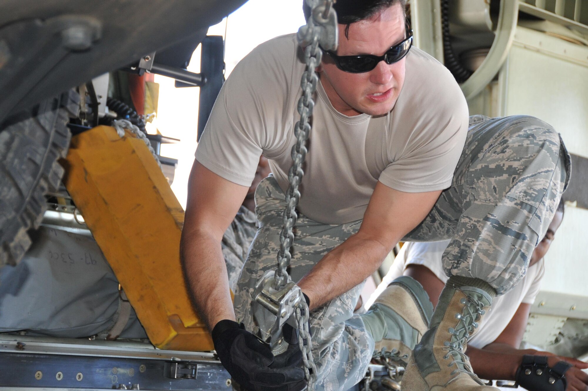 Team Entrekin member, Master Sgt. James Comstock, 41st Aerial Port Squadron air transportation specialist quality assurance, completes the tie-down steps of securing a Humvee inside a C-130J aircraft during the annual Port Dawg Challenge here Oct. 14, 2017.  Members of the 41st Aerial Port Squadron competed in teams during the annual Port Dawg Challenge, which consisted of five events: cargo pallet build-up, chains and devices, forklift obstacle course, Jeopardy, and a Fit-to-Fight relay.  (U.S. Air Force Photo/ Master Sgt. Jessica Kendziorek)