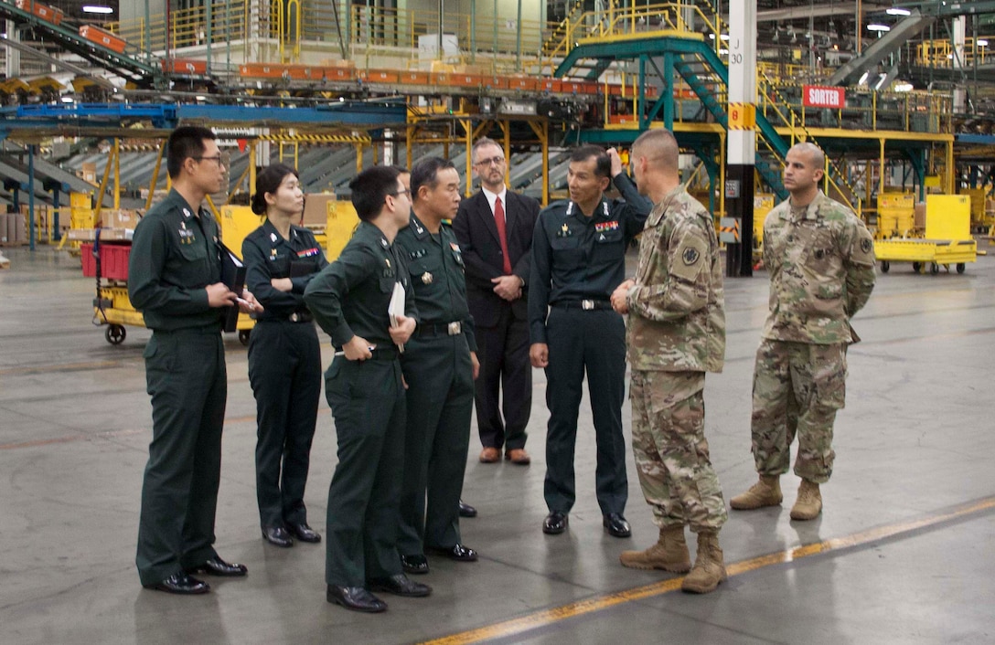 Republic of Korea Army Logistics Command commanding general Lt. Gen. Lee, Jeong Keun, center, and several other ROK ALC representatives tour DLA Distribution Susquehanna, Pa.’s Eastern Distribution Center, the largest distribution center within the Department of Defense.