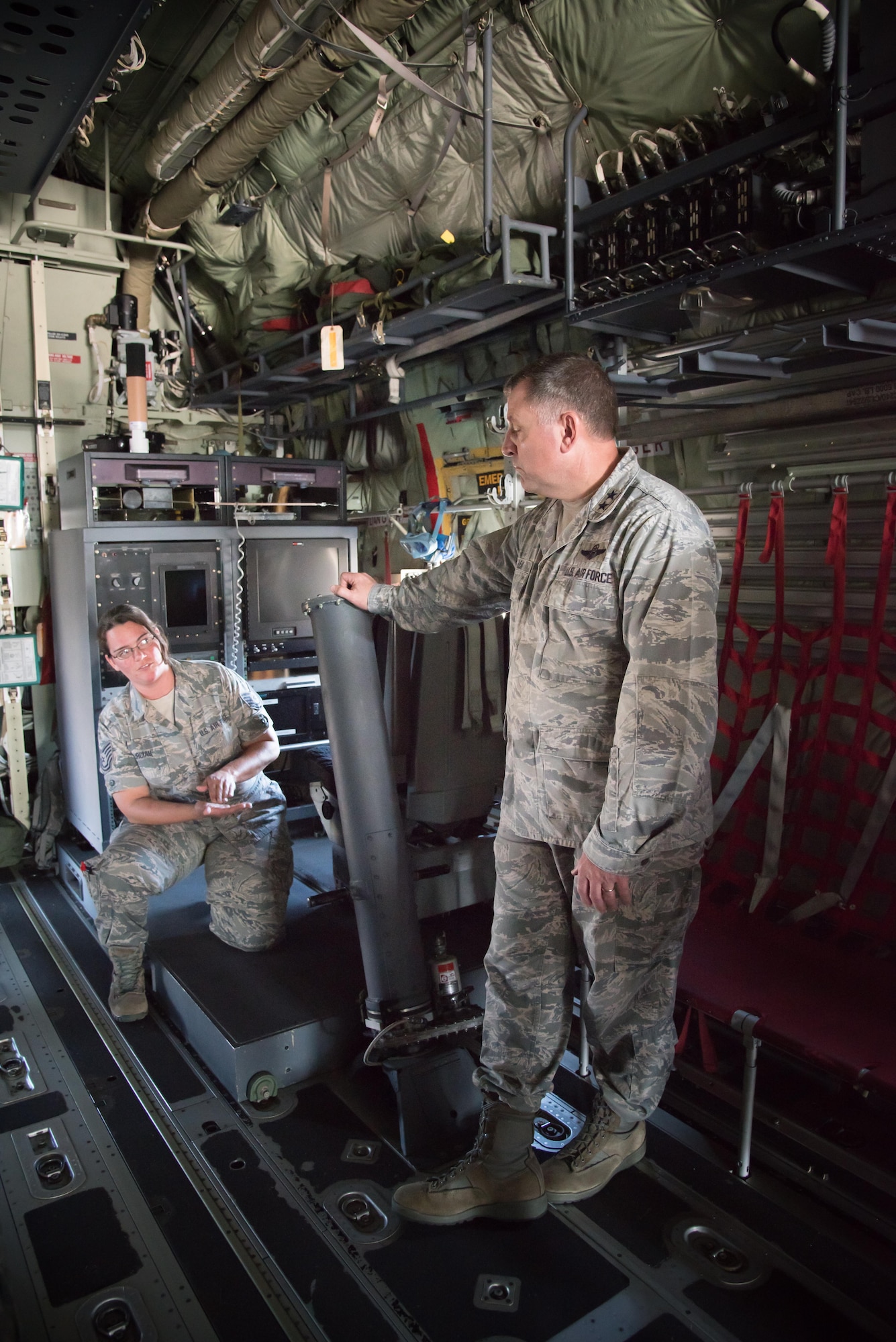 Maj. Gen. Timothy Leahy, 2nd Air Force commander, discusses the modifications required on WC-130J Super Hercules aircraft to complete the Hurricane Hunter mission with Tech. Sgt. Crystal Pourciau, 403rd Aircraft Maintenance Squadron, during his immersion tour of the 403rd Wing Oct. 13, 2017 at Keesler air Force Base, Mississippi. (U.S. Air Force photo/Staff Sgt. Heather Heiney)