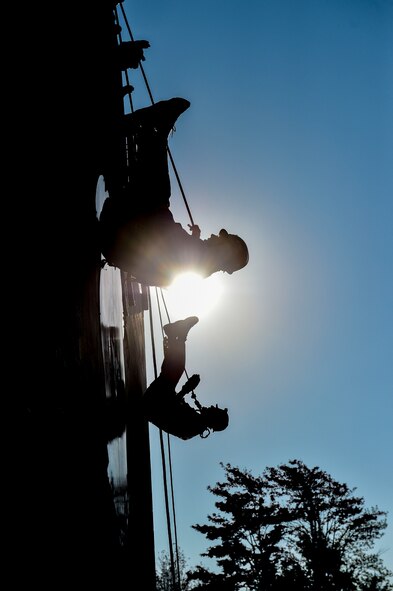 Daniel R. Sitterly, Acting Assistant Secretary of the Air Force for Manpower and Reserve Affairs, and Lt. Col. Albert Bosco, an Executive Officer from Headquarters Air Force, rappel upside down during a demonstration Oct. 14, 2017, at Youngstown Air Reserve Station.