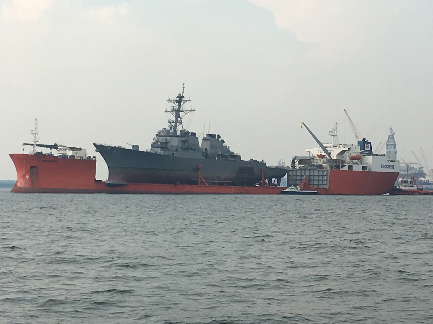 SINGAPORE – (Oct. 7, 2017) – MV Treasure concludes USS John S. McCain (DDG 56) heavy lift operations in the Singapore Strait, Oct. 7. U.S. Navy Supervisor of Salvage and Diving representatives prepared the destroyer for transit to Yokosuka, Japan, later this month.
