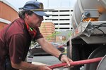 DLA team members pulls a fuel hose
