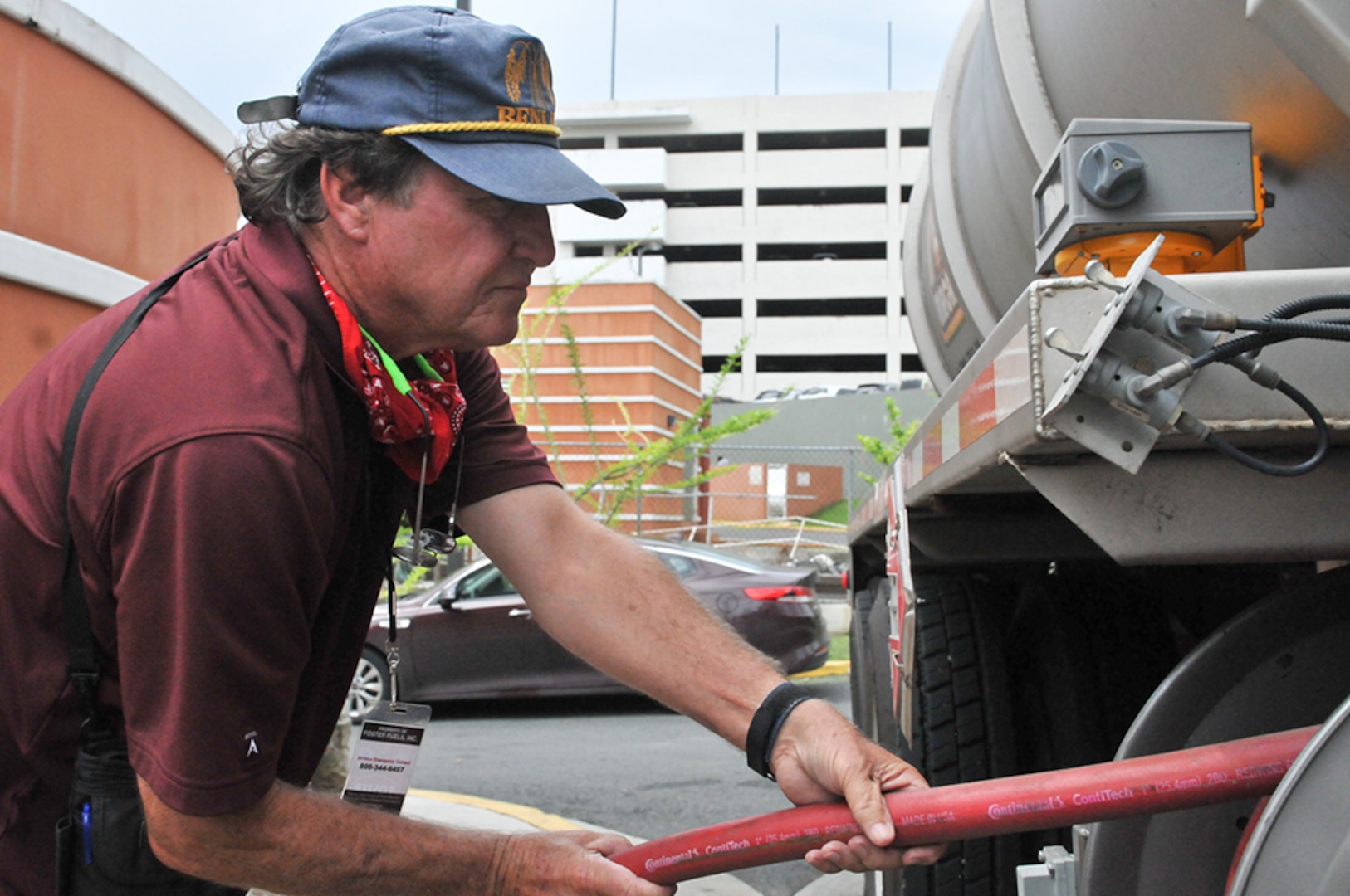 DLA team members pulls a fuel hose