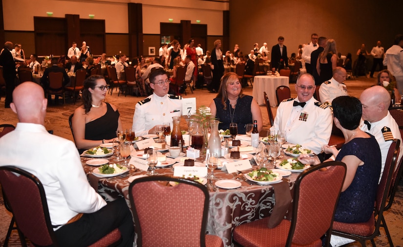 Joint Base Charleston Navy Sailors and their families converse during dinner at the Navy’s 242nd birthday ball in Charleston, S.C., Oct. 14, 2017.