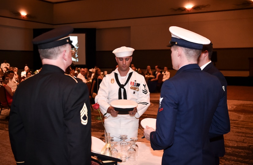 Honor Guardsmen from each service branch honor POWs and MIAs before the start of the Navy’s 242nd birthday ball in Charleston, S.C., Oct. 14, 2017.