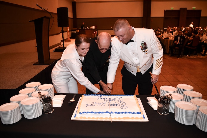 The youngest and oldest Sailor at the Navy’s 242nd birthday ball cut the cake with Naval Support Activity Command Master Chief Asa Worcester, Oct. 14, 2017.