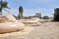 Large water bags sit on the group partially filled.