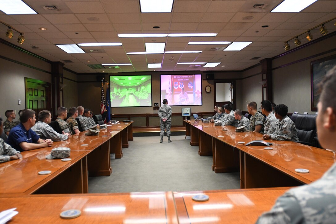 Airman 1st Class Kaitlyn Griffin, 335th Training Squadron student, delivers a mission and regional weather forecast to Lt. Gen. Richard Clark, 3rd Air Force commander, Ramstein Air Base, Germany, via a video teleconference at Stennis Hall Oct. 12, 2017, on Keesler Air Force Base, Mississippi. Griffin, accompanied by fellow students, delivered the forecast as a training demonstration as well as a mentorship opportunity. (U.S. Air Force photo by Kemberly Groue)