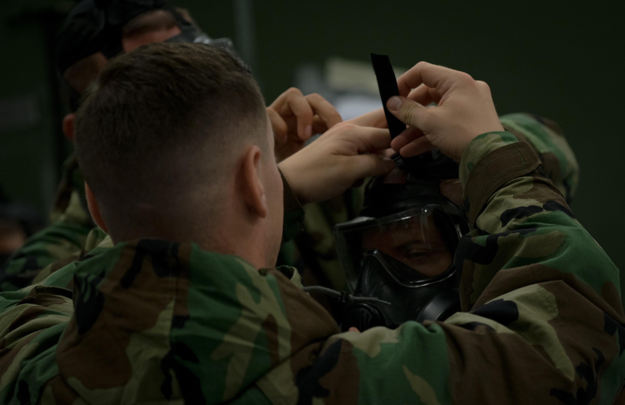 Members from the 403rd Wing help each other into their MOPP Gear during a training on October 15, 2017 at Keesler Air Force Base, Mississippi. The Mission Oriented Protective Posture (MOPP) Gear is used to protect members during chemical, biological, radiological and nuclear attacks. (U.S. Air Force photo/Staff Sgt. Shelton Sherrill)