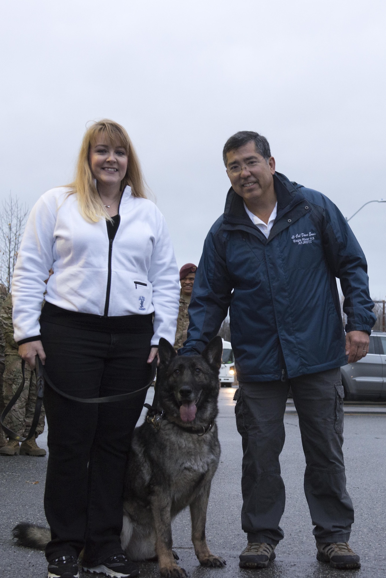 Retired Air Force Lt. Col. David Ennis and wife Lisa, hold the leash of their newly adopted dog, Ajax, Oct. 13, 2017, on Joint Base Elmendorf-Richardson, Alaska. Ajax retired after nine years of service at JBER.
