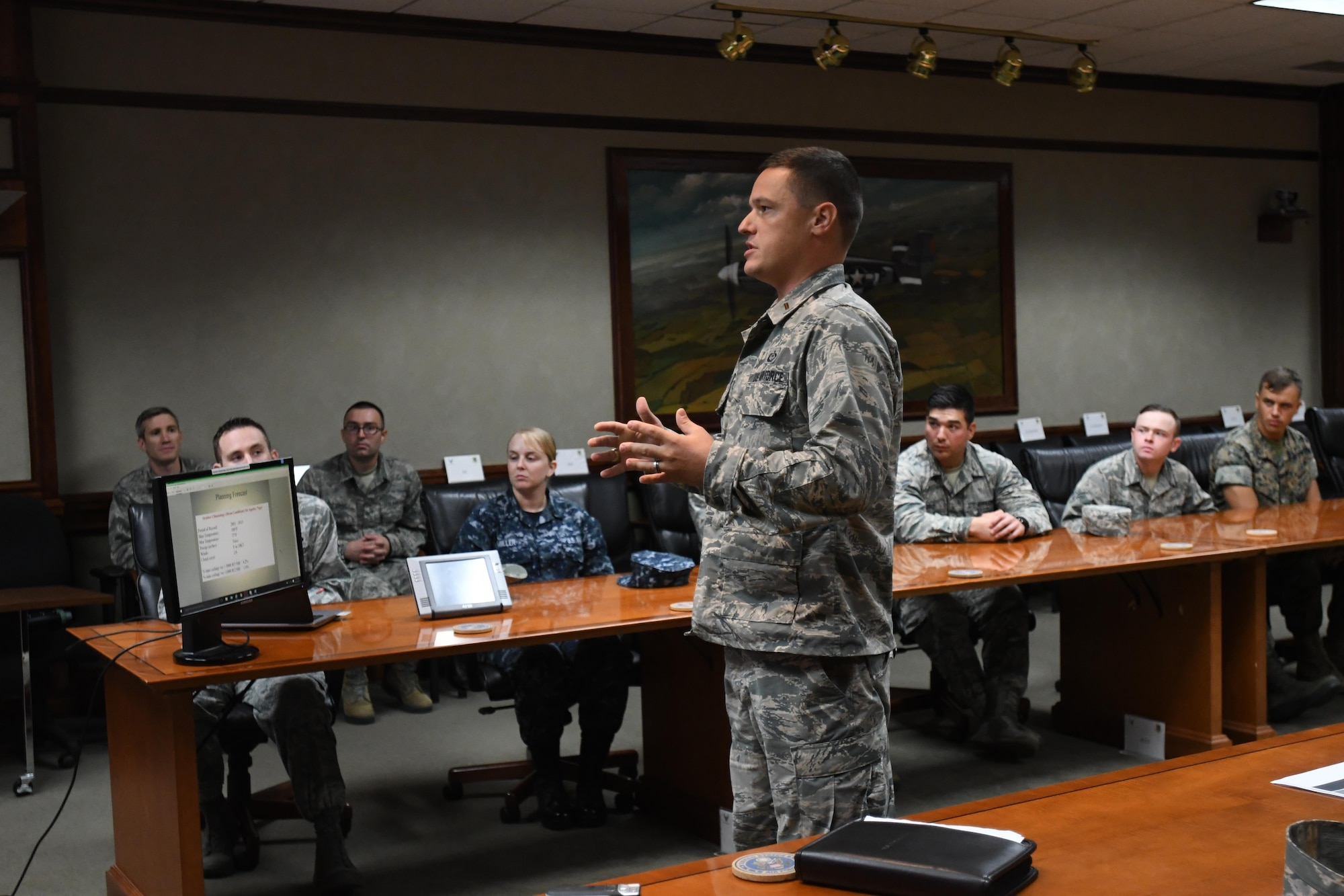 Second Lt. James Merritt, 335th Training Squadron student, delivers a mission and regional weather forecast to Lt. Gen. Richard Clark, 3rd Air Force commander, Ramstein Air Base, Germany, via a video teleconference at Stennis Hall Oct. 12, 2017, on Keesler Air Force Base, Mississippi. Merritt, accompanied by fellow students, delivered the forecast as a training demonstration as well as a mentorship opportunity. (U.S. Air Force photo by Kemberly Groue)