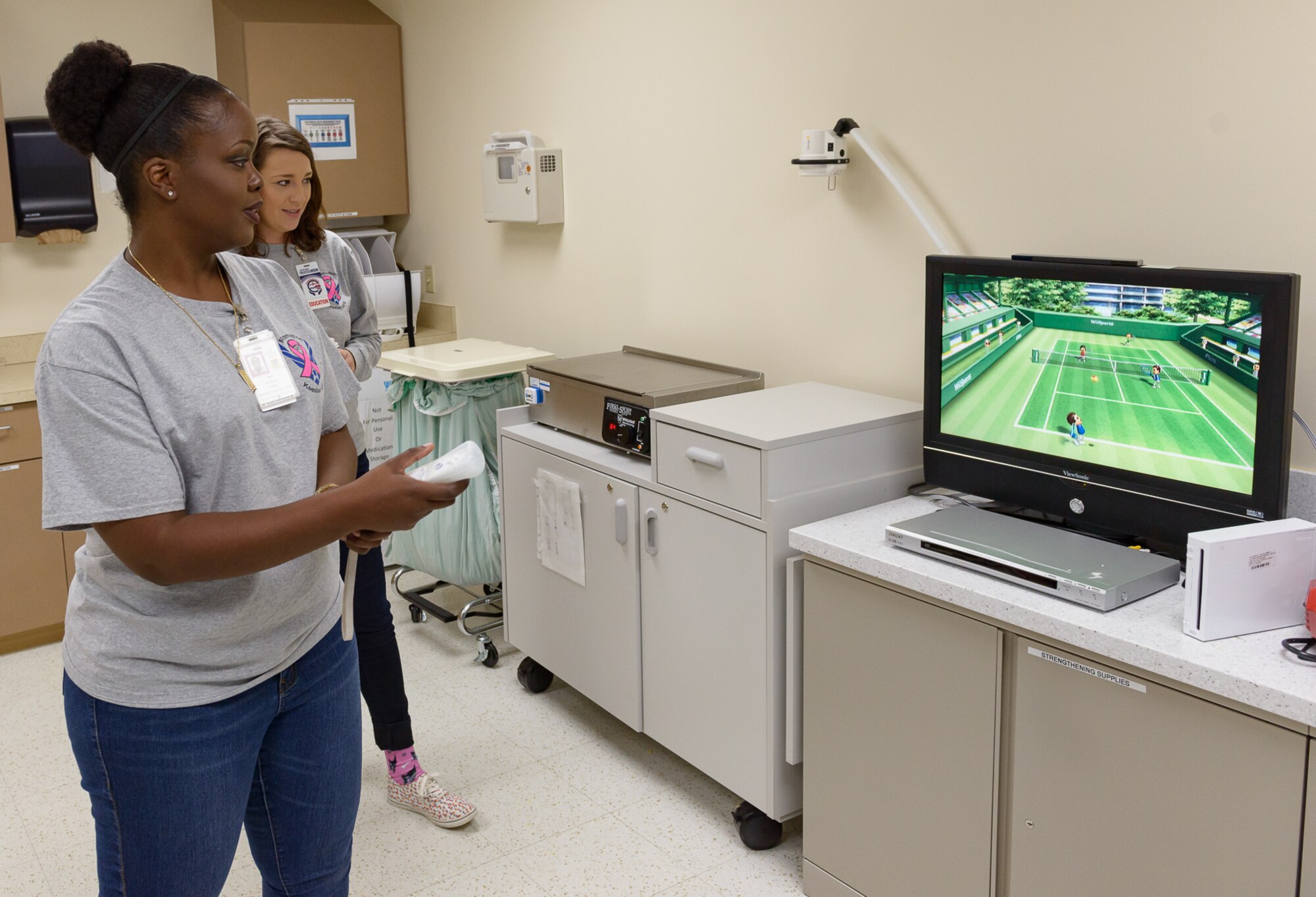 Senior Airman Alishia Loper and Staff Sgt. Leanne Kirk, 81st Medical Group education and training medical administration, test their range of motion using video game console at the Physical and Occupational Therapy clinic open house Oct. 13, 2017, on Keesler Air Force Base, Mississippi. The event was held in celebration of National Physical Therapy and Chiropractic Month and housed several demonstrations to include dry needling, anti-gravity treadmill and power lifting techniques. (U.S. Air Force photo by Andre’ Askew)