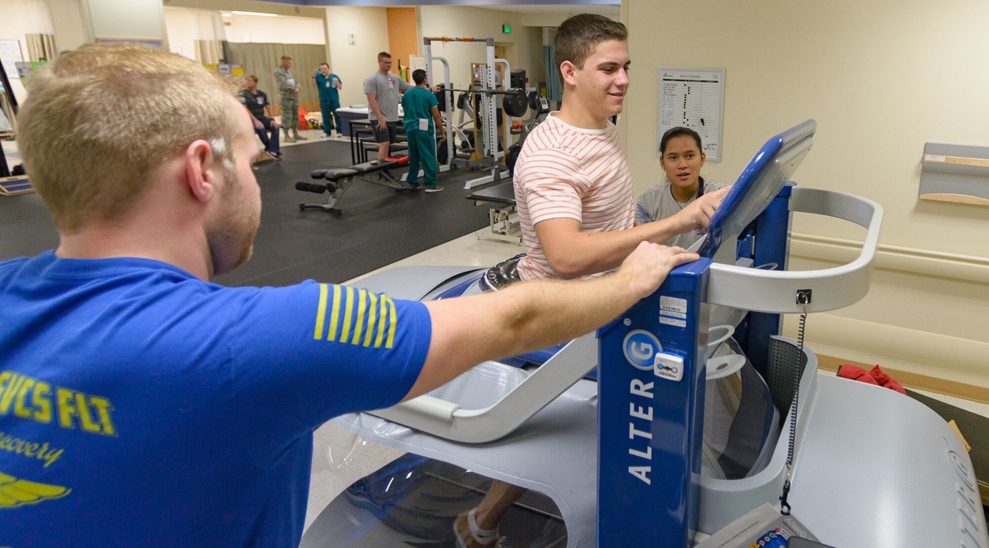 Jack Camoratto, brother of Dr. Joseph Camoratto, 81st Surgical Operations Squadron doctor of physical therapy, runs on the Anti-Gravity treadmill as Daniel Roquemore and Jaymee Cruz, 81st Surgical Operations Squadron physical therapy students, look on at the Physical and Occupational Therapy clinic open house Oct. 13, 2017, on Keesler Air Force Base, Mississippi. The event was held in celebration of National Physical Therapy and Chiropractic Month and housed several demonstrations to include dry needling, anti-gravity treadmill and power lifting techniques. (U.S. Air Force photo by Andre’ Askew)