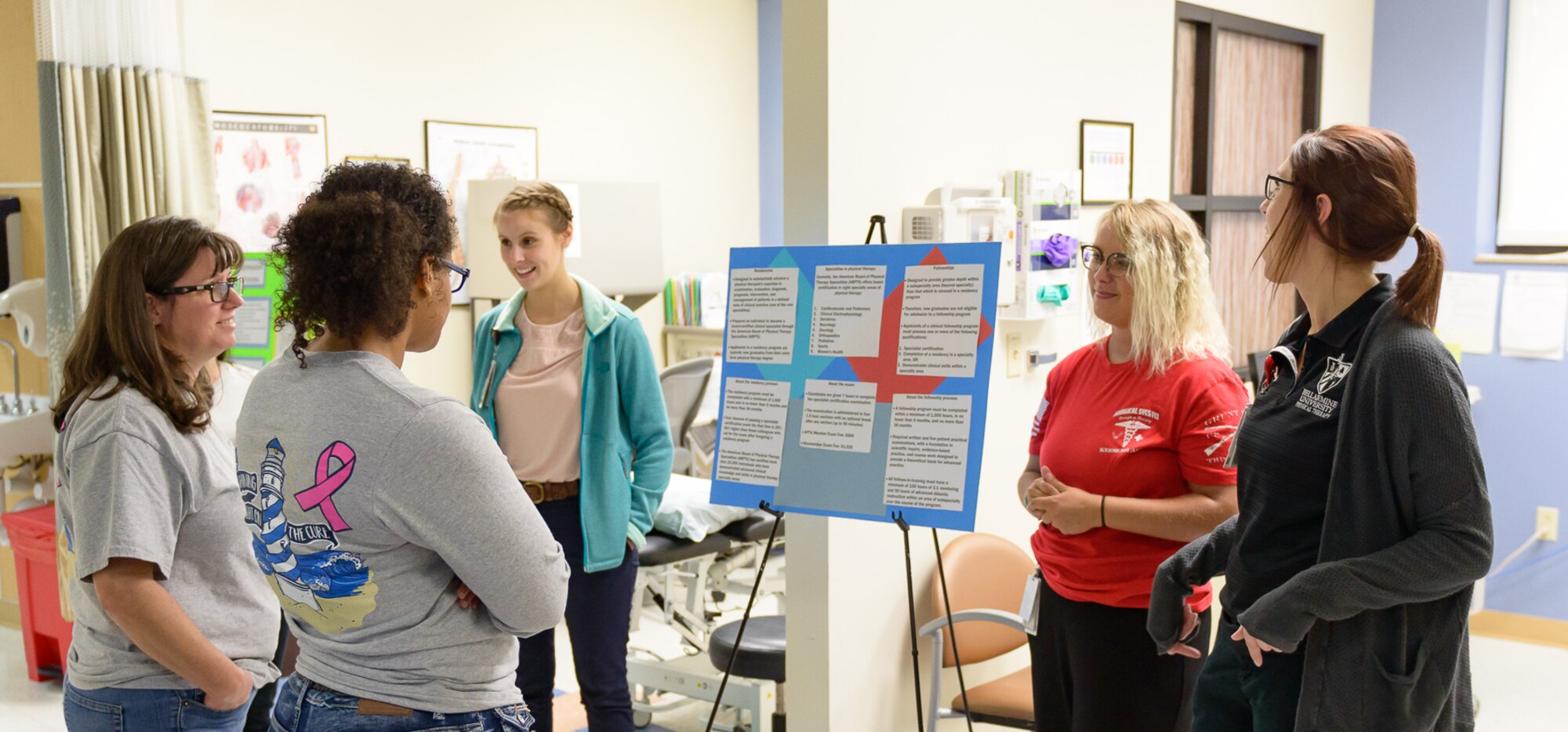Physical Therapy interns brief their role and career path to visitors at the Physical and Occupational Therapy clinic open house Oct. 13, 2017, on Keesler Air Force Base, Mississippi. The event was held in celebration of National Physical Therapy and Chiropractic Month and housed several demonstrations to include dry needling, anti-gravity treadmill and power lifting techniques. (U.S. Air Force photo by Andre’ Askew)