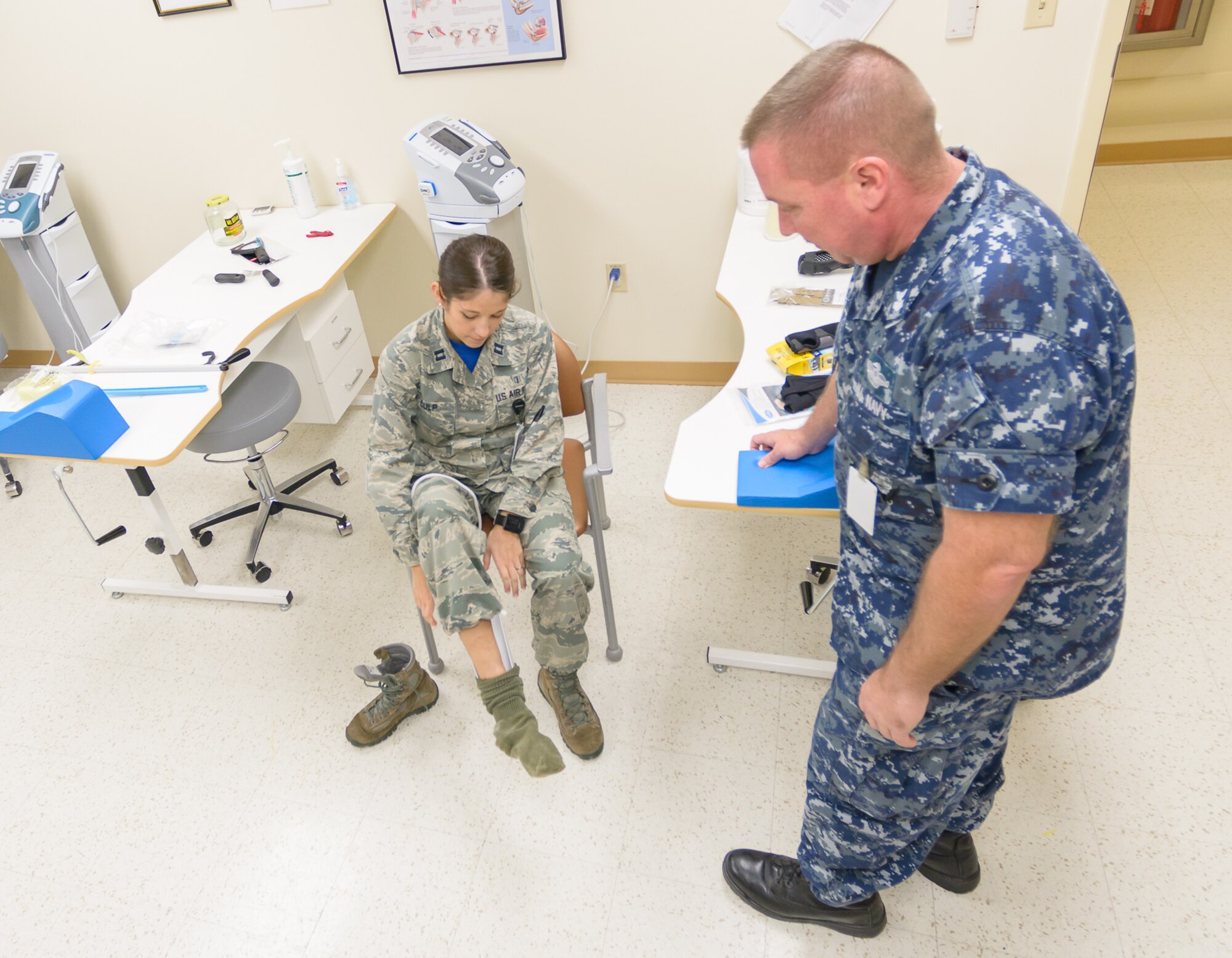 Capt. Francesca Culp, 81st Surgical Operations Squadron occupational therapist, demonstrates the sock aide adapter to Hospital Corpsman First Class Joseph Baer, 81st Medical Support Squadron Navy-Marine liaison, at the Physical and Occupational Therapy clinic open house Oct 13, 2017, on Keesler Air Force Base, Mississippi. The event was held in celebration of National Physical Therapy and Chiropractic Month and housed several demonstrations to include dry needling, anti-gravity treadmill and power lifting techniques. (U.S. Air Force photo by Andre’ Askew)