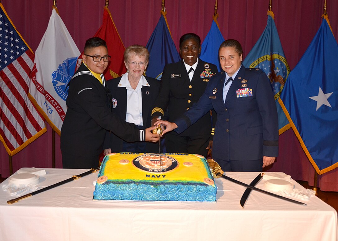 Members of the party cut the cake.