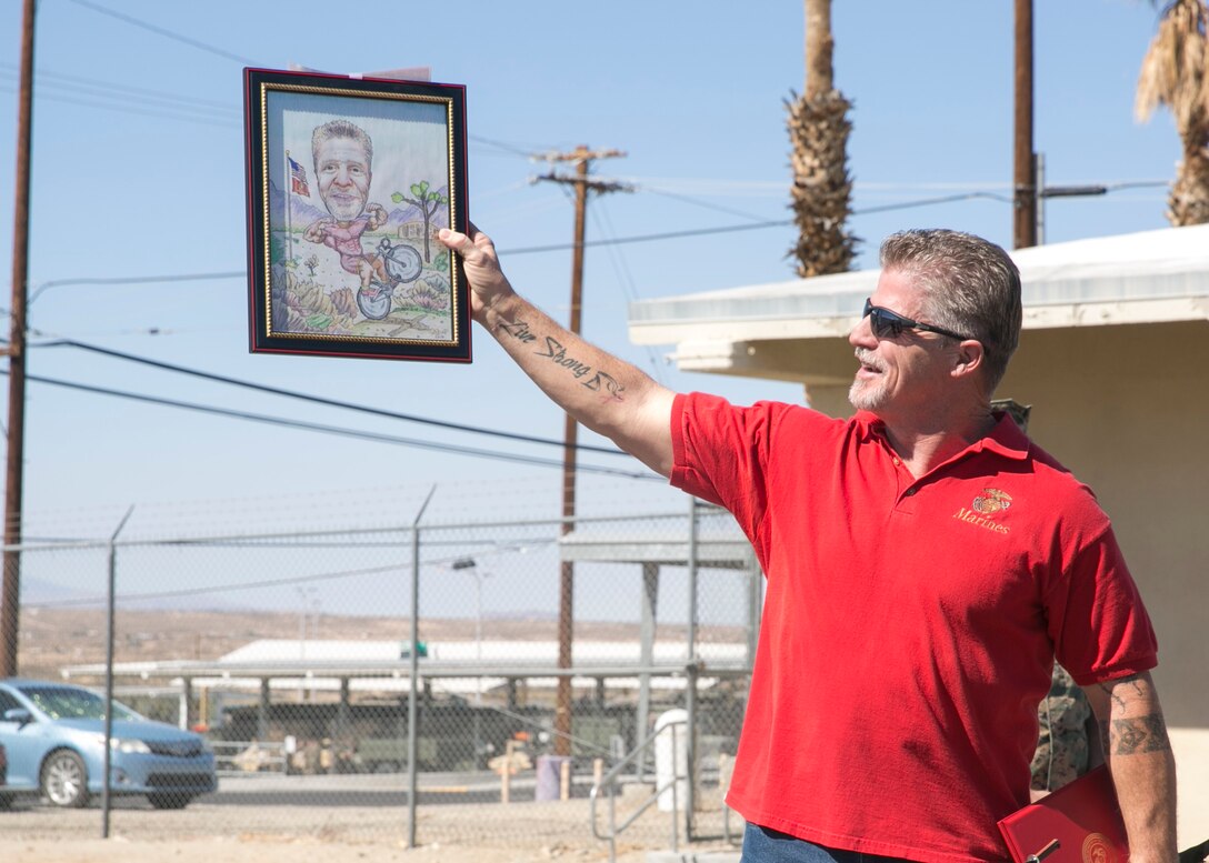 Michael Ray, a worker with Public Works Division, shows off a gift from his coworkers during an award ceremony at the Public Works Division Compound aboard the Marine Corps Air Ground Combat Center, Twentynine Palms, Calif., October 10, 2017. Ray received the gift from his coworkers to show their appreciation for his hard work and dedication to his career. (U.S. Marine Corps photo by Lance Cpl. Isaac Cantrell)