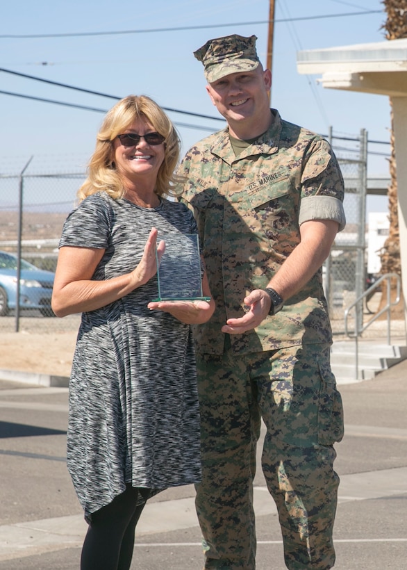 Col. Jay Wylie, assistant chief of staff, Installation Support Directorate, presents Vickie Hatch, a worker with Public Works Division, a support excellence award during an award ceremony at the Public Works Division Compound aboard the Marine Corps Air Ground Combat Center, Twentynine Palms, Calif., October 10, 2017. Hatch received the award for her hard work and dedication to PWD and the Combat Center. (U.S. Marine Corps photo by Lance Cpl. Isaac Cantrell)