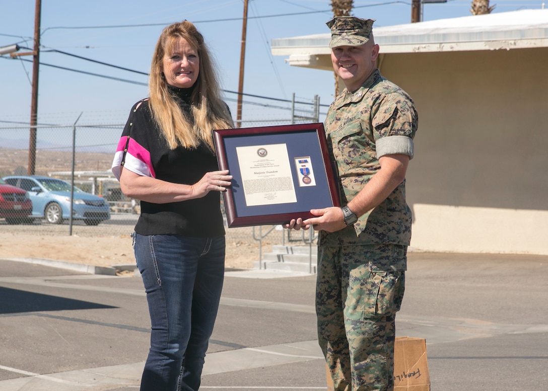 Col. Jay Wylie, assistant chief of staff, Installation Support Directorate, presents Marjorie Trandem, a worker with Public Works Division, a meritorious civilian service award, during an award ceremony at the Public Works Division Compound aboard the Marine Corps Air Ground Combat Center, Twentynine Palms, Calif., October 10, 2017. (U.S. Marine Corps photo by Lance Cpl. Isaac Cantrell)