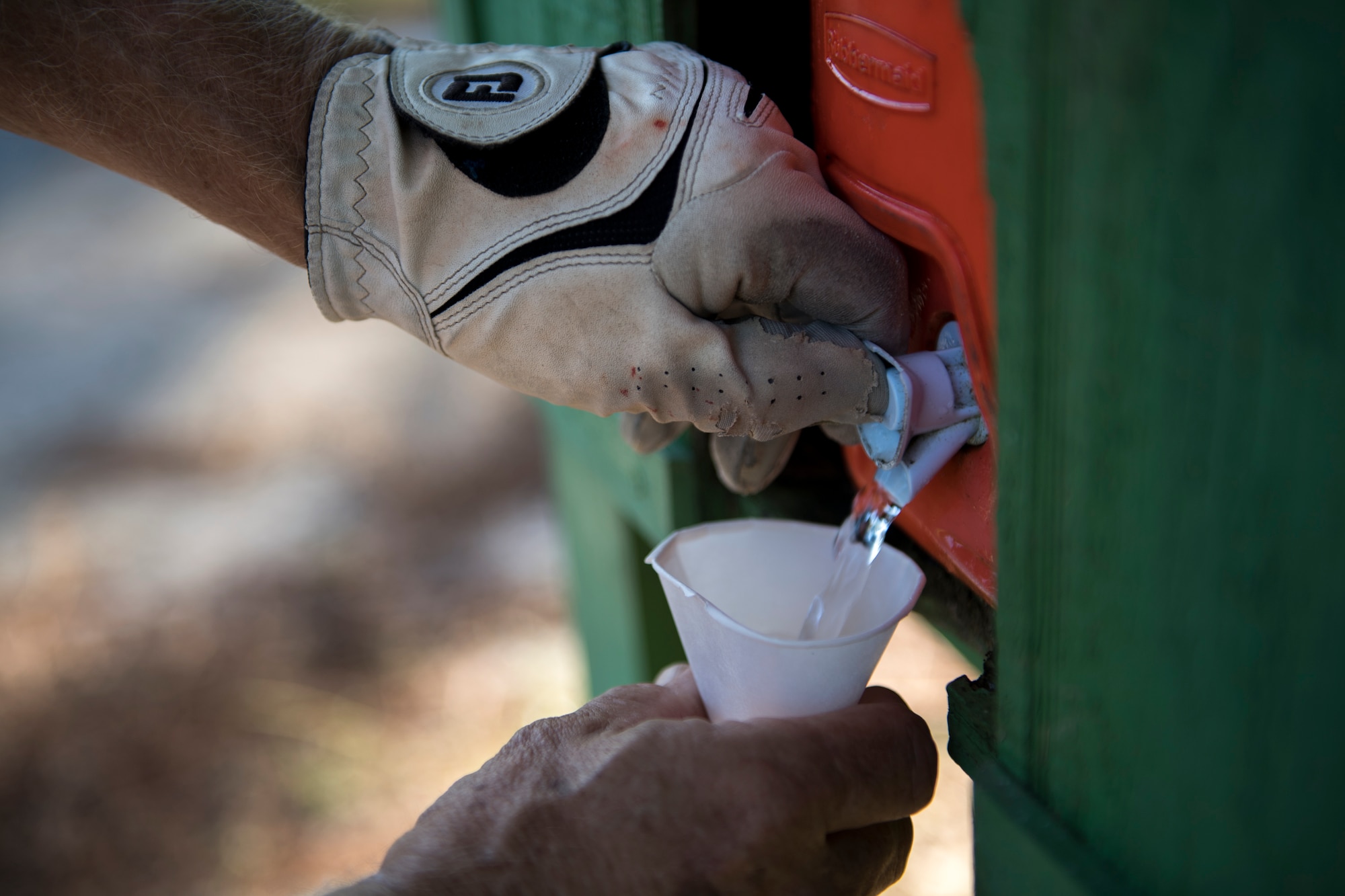 A retiree gets a cup of water during a Retiree Appreciation Week golf tournament, Oct. 13, 2017, at the Quiet Pines golf course on Moody Air Force Base, Ga. Retired Chief Master Sgt. James Ingram, director of the Retiree Affairs Office, created the annual event in the 1990’s to bring retirees together and make them feel welcomed in the base community. (U.S. Air Force photo by Senior Airman Daniel Snider)
