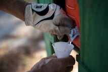 A retiree gets a cup of water during a Retiree Appreciation Week golf tournament, Oct. 13, 2017, at the Quiet Pines golf course on Moody Air Force Base, Ga. Retired Chief Master Sgt. James Ingram, director of the Retiree Affairs Office, created the annual event in the 1990’s to bring retirees together and make them feel welcomed in the base community. (U.S. Air Force photo by Senior Airman Daniel Snider)
