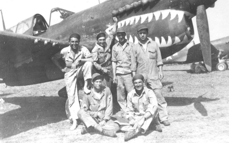 A group of 33rd Fighter Group members gather in front of a P-40 Warhawk. (Courtesy Photo)