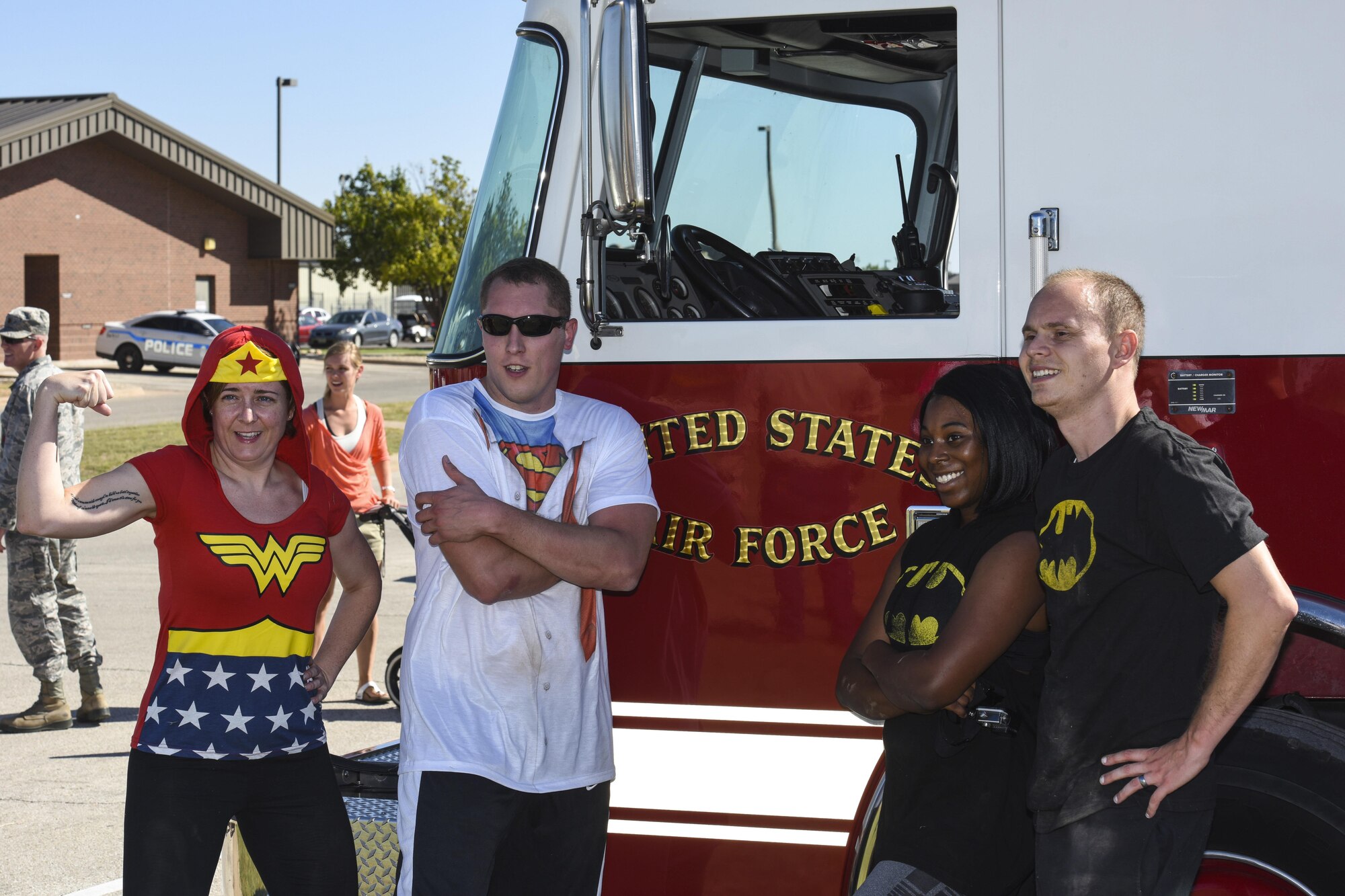 The 17th Training Wing Public Affairs team, consisting of Master Sgt. Joy Meek, superintendent, Staff Sgt. Anthony Hetlage, broadcast journalist journeyman, 1st Lt. Tisha Wilkerson, media operations, and James Orlando, visual information specialist, pose after completing the Fire Muster Challenge beside the Fire Department on Goodfellow Air Force Base, Texas Oct. 13, 2017. The Fire Muster Challenge tested a team’s strength and ability to work together. (U.S. Air Force photo by Airman 1st Class Zachary Chapman/Released)