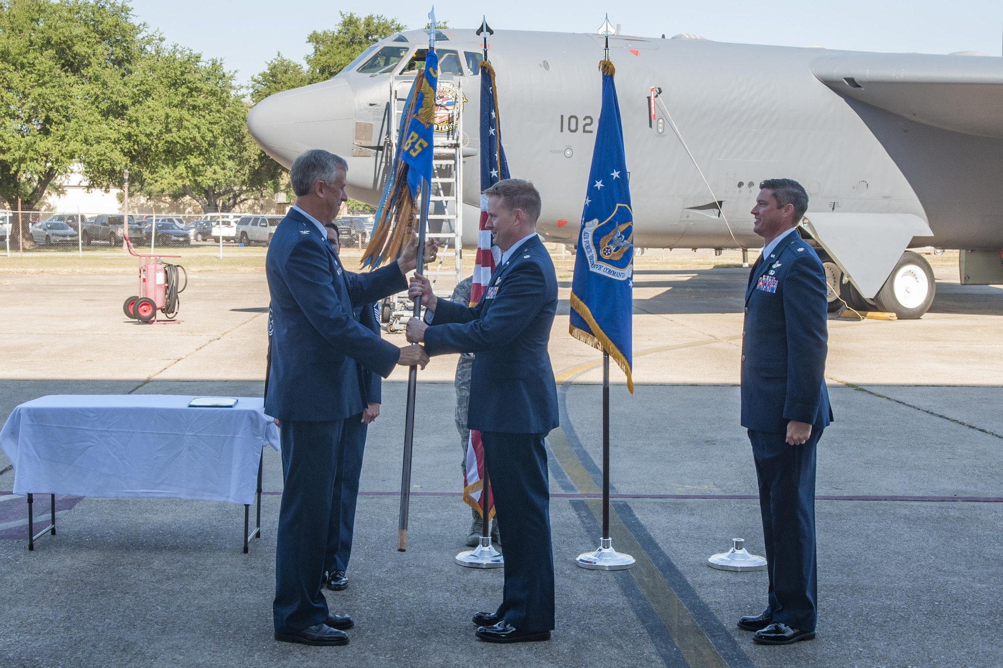 U.S. Air Force Col. Robert Burgess, 307th Operations Group commander, passes the 93rd Bomb Squadron’s guidon to Lt. Col. Bryan Bailey, the new 93rd Bomb Squadron commander, at Barksdale Air Force Base, La., Oct. 15, 2017.