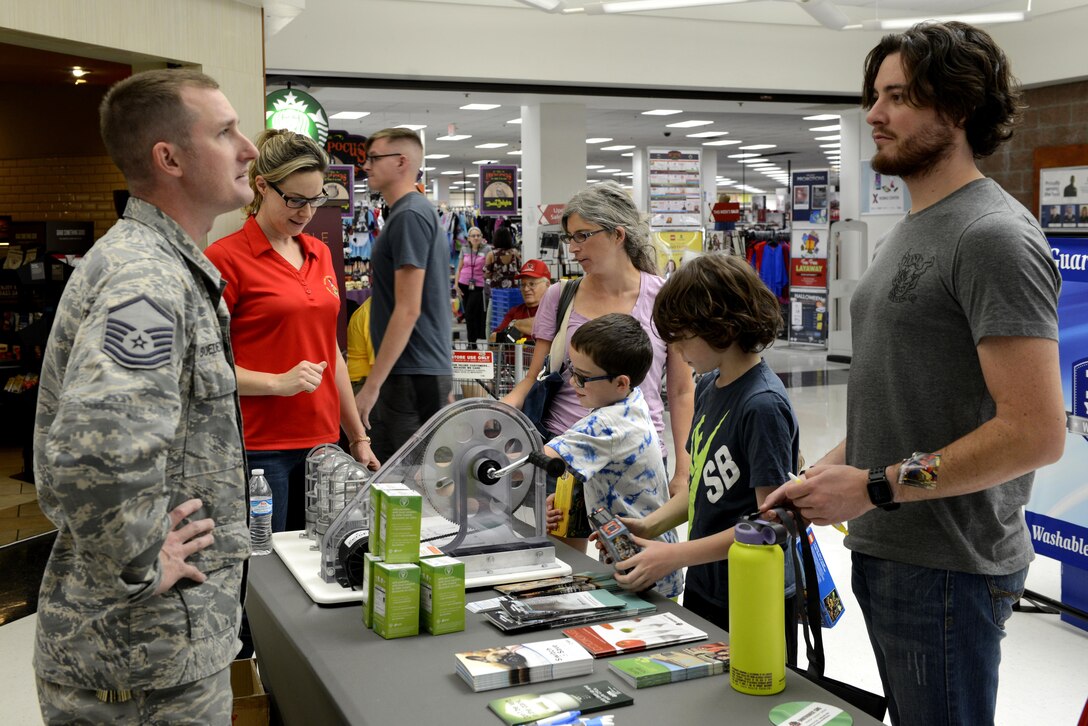 Master Sgt. Benjamin Boedecker, 56th Civil Engineering Squadron utilities manager, gives energy saving information to a Thunderbolt at Luke Air Force Base, Ariz. Oct. 13, 2017. The booth provided Thunderbolts information on energy efficiency during National Energy Awareness Month
