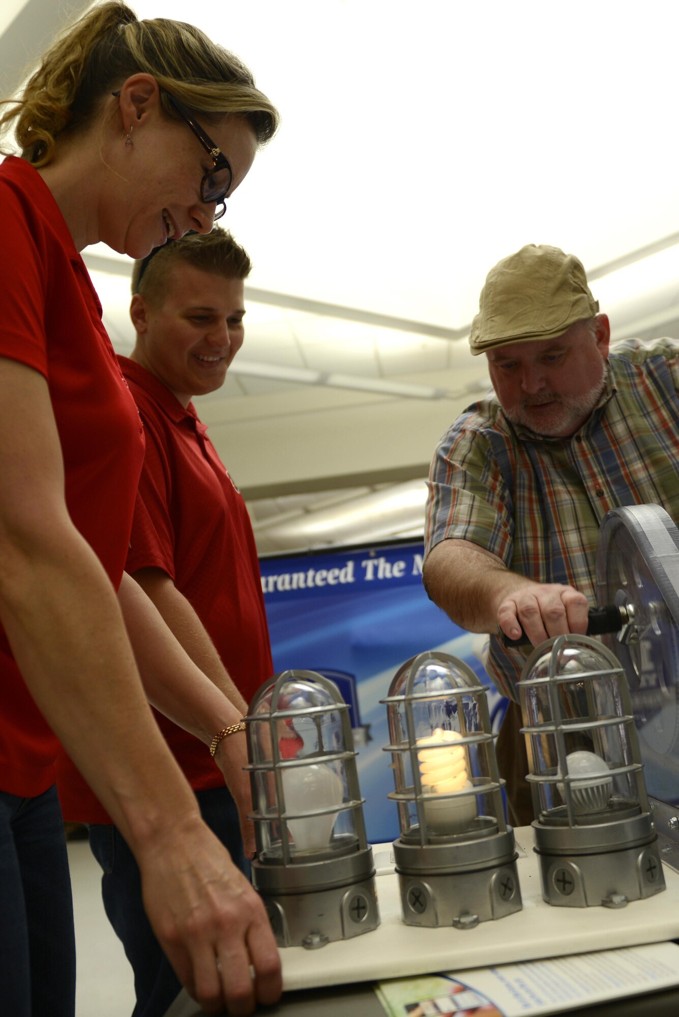 Christine Archie, 56th Civil Engineering Squadron energy manager, demonstrates how much effort is required to power a light bulb at Luke Air Force Base, Ariz. Oct. 13, 2017. The power generating mechanism differentiated the amount of energy needed to power each light bulb separately as part of efforts to raise awareness during National Energy Awareness Month.