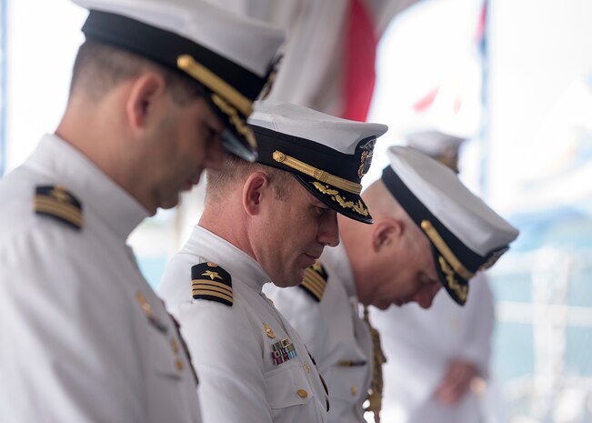 The official party bow for the invocation during the Naval Submarine Support Command (NSSC) Pearl Harbor change of command ceremony aboard the Battleship Missouri Memorial in Pearl Harbor, Hawaii.   (U.S. Navy photo by Mass Communication Specialist 2nd Class Michael Lee/Released)