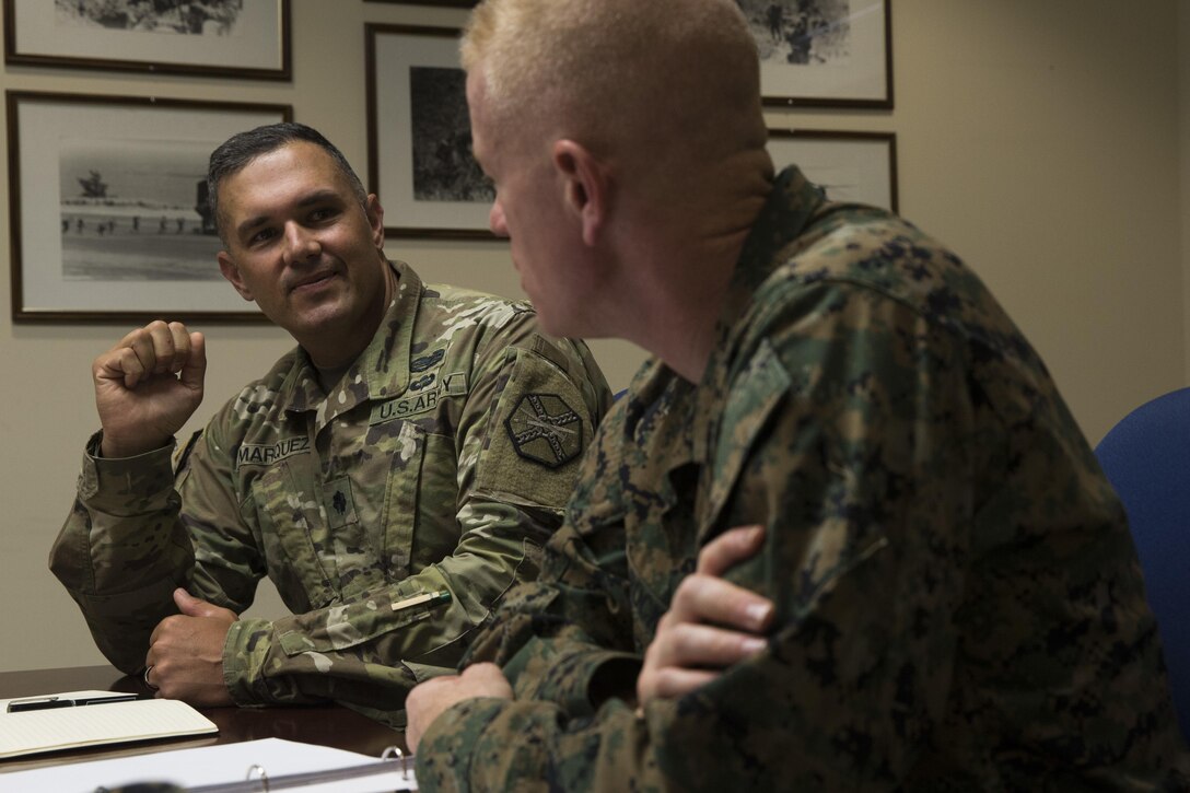 U.S. Marine Corps Brig. Gen. Paul Rock Jr., Marine Corps Installations Pacific commanding general, speaks with U.S. Army Lt. Col. Christopher Marquez, commanding officer of Pōhakuloa Training Area (PTA), Hawaii, Oct. 11, 2017. Brig. Gen. Rock visited Marine Corps Base Hawaii and its various bases to survey the Marines and their infrastructure, training and operations. (U.S. Marine Corps Photo by Sgt. Alex Kouns)