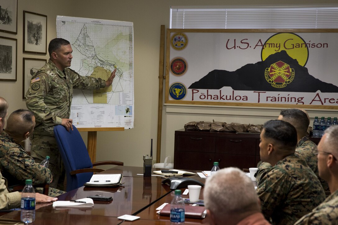 U.S. Army Lt. Col. Christopher Marquez,  commanding officer of Pōhakuloa Training Area, Hawaii, provides information regarding the local area during a brief at Pōhakuloa Training Area, Hawaii, Oct. 11, 2017. Brig. Gen. Rock visited Marine Corps Base Hawaii and its various bases to survey the Marines and their infrastructure, training and operations. (U.S. Marine Corps Photo by Sgt. Alex Kouns)