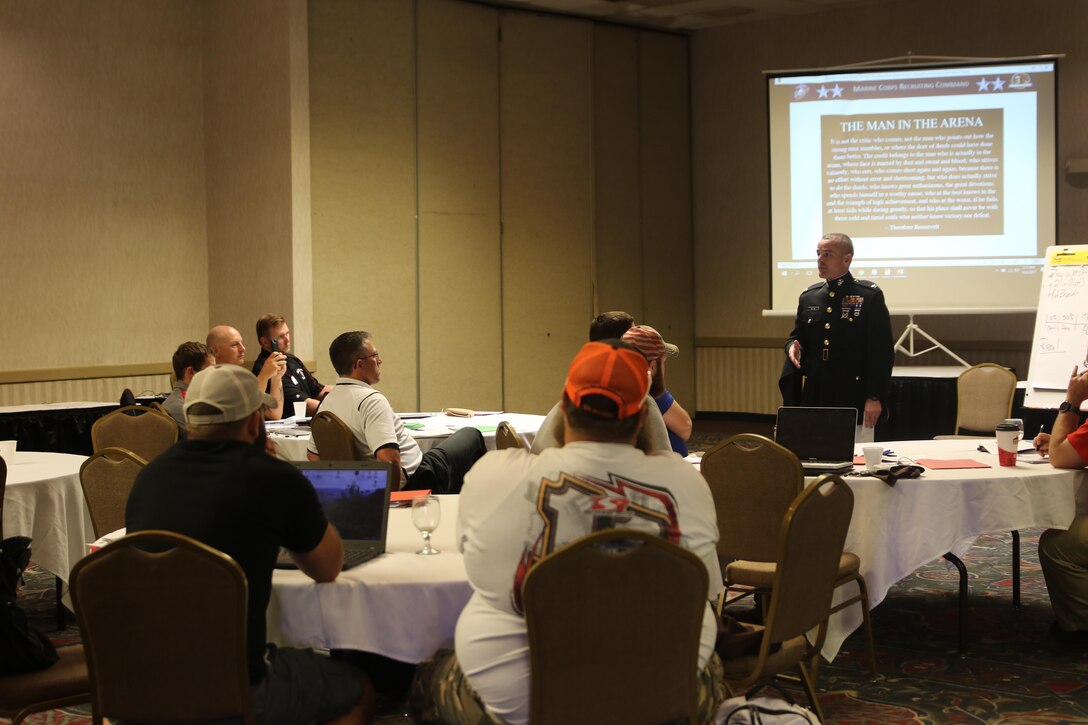 Colonel David Fallon, the 9th Marine Corps District commanding officer, speaks with wrestling coaches during the National Wrestling Coaches Association’s Leadership Academy in Salina, Kan., Oct. 6. Fallon spoke to coaches about the traits between Marines and wrestlers share. In November 2016, the Marine Corps expanded its marketing efforts into the wrestling world to locate and recruit men and women who the Marine Corps believes will be successful in all military occupational specialties. (Official U.S. Marine photo by Sgt. Francisco Martinez)