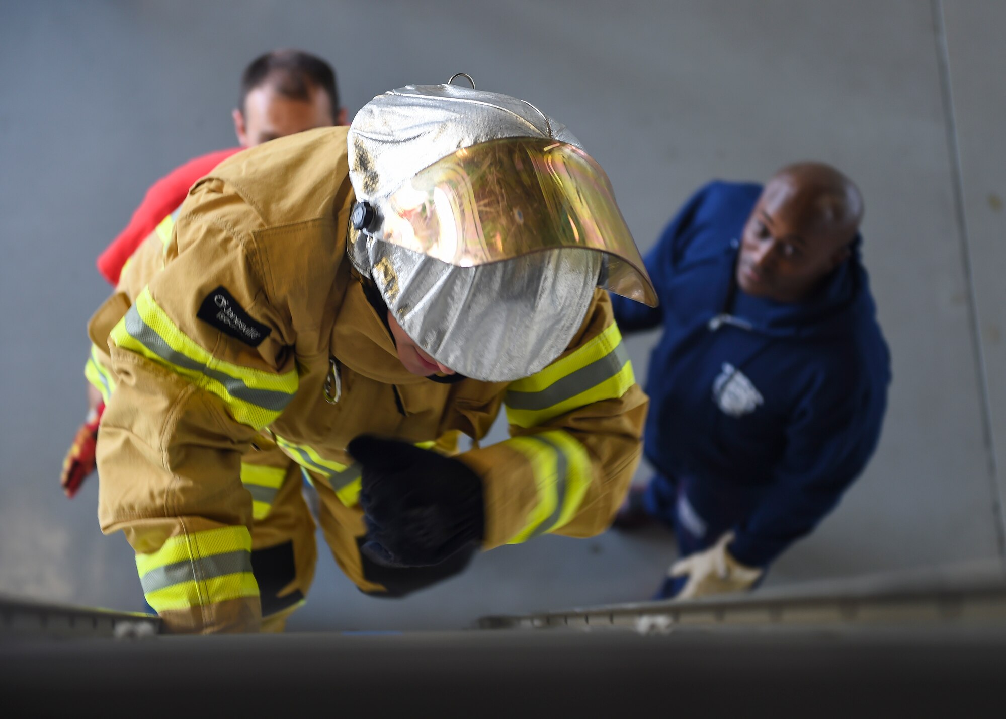 A U.S. Air Force Airman climbs a ladder during the Fire Prevention Week Firefighter’s Combat Challenge at Joint Base Langley-Eustis, Va., Oct. 13, 2017.