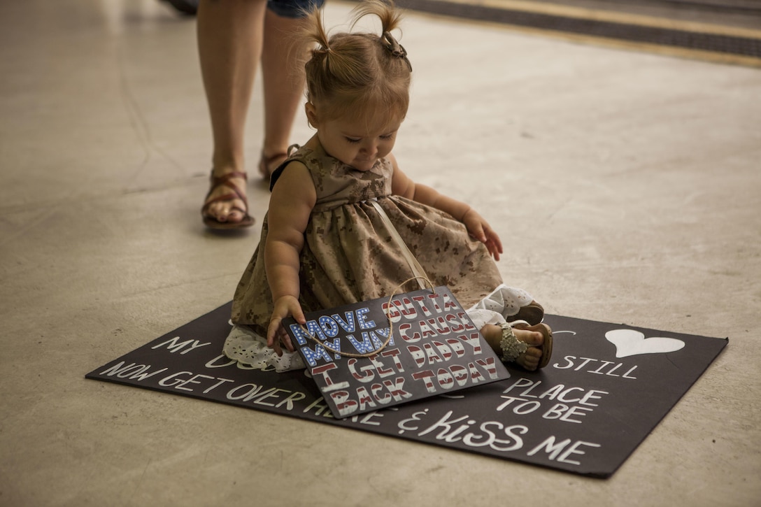A daughter of a Marine with Marine Tactical Electronic Warfare Squadron 3, awaits to greet her father as he returns from deployment at Marine Corps Air Station Cherry Point, N.C., Oct. 14, 2017. VMAQ- 3 was reunited with their families after a six month deployment to Turkey.