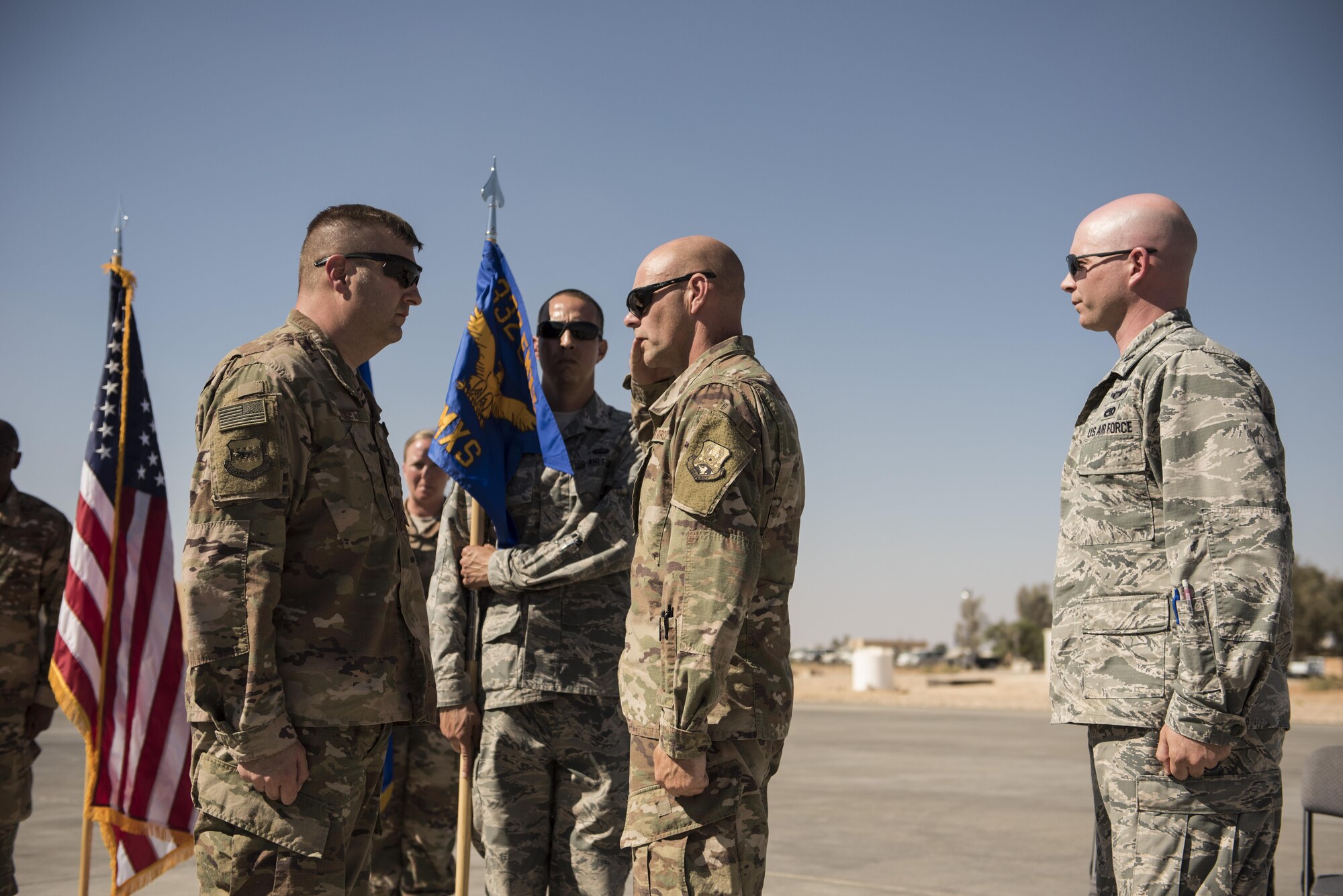Outgoing 332nd Expeditionary Maintenance Squadron commander, Lt. Col. Kenneth Fetters, salutes Col. Shane Barrett, 332nd Expeditionary Maintenance Group commander as he relinquishes command to Lt. Col. Scott May, October 6, 2017 in Southwest Asia. Lt. Col. Fetters and his Airmen leave behind a perfect record of zero combat sorties missed, as they prepared aircraft in support of Operation Inherent Resolve. (U.S. Air Force photo by Senior Airman Joshua Kleinholz)