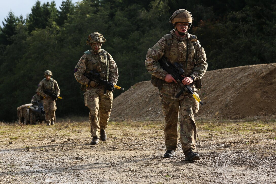 British soldiers participate in a ruck march while conducting a security patrol.