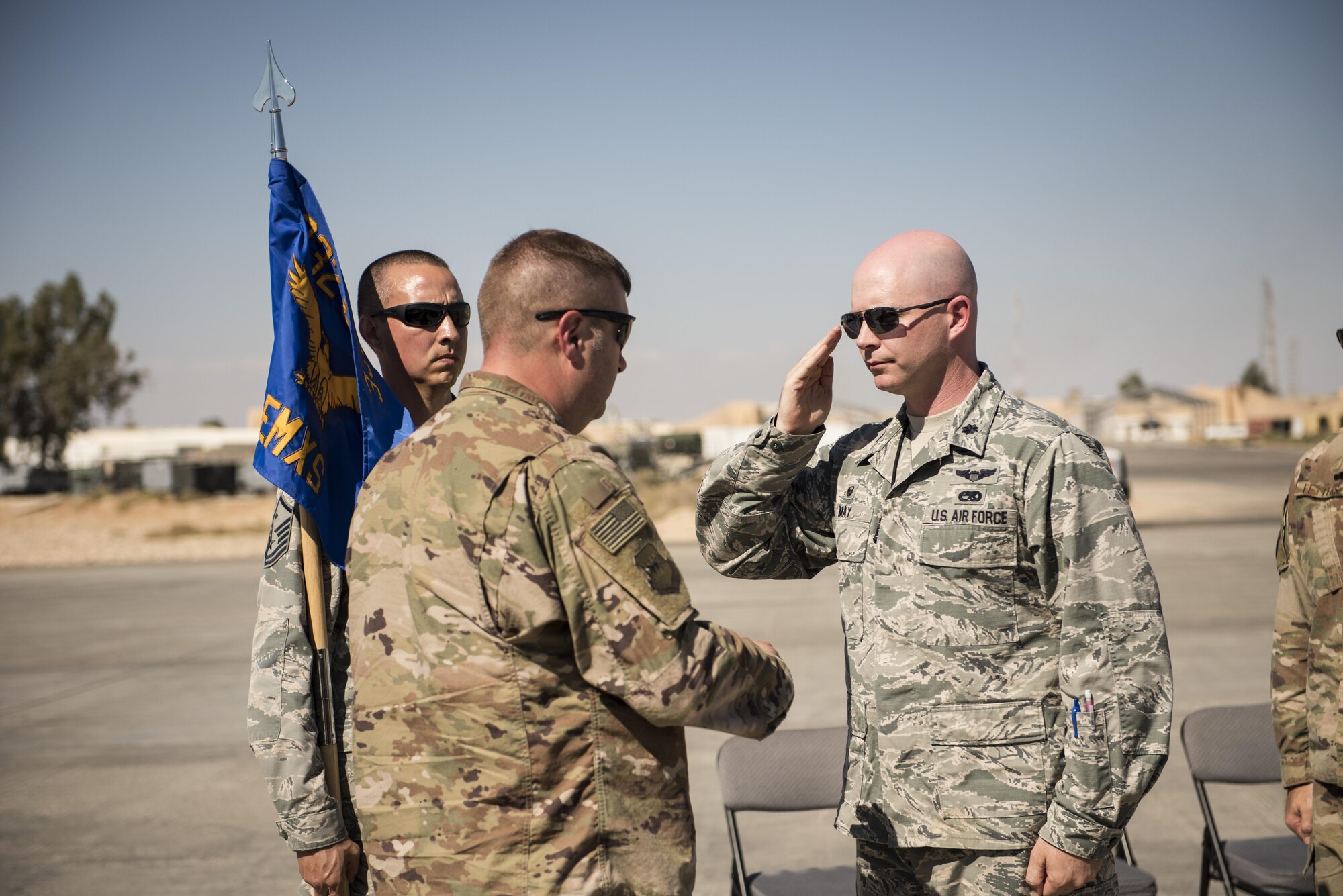 Lt. Col. Scott May salutes Col. Shane Barrett, 332nd Expeditionary Maintenance Group commander, as he assumes command of the 332nd Expeditionary Maintenance Squadron October 6, 2017, during a change of command ceremony in Southwest Asia. The 332nd EMXS is responsible for all aspects of maintenance on F-15E Strike Eagles supporting Operation Inherent Resolve. (U.S. air Force photo by Senior Airman Joshua Kleinholz)