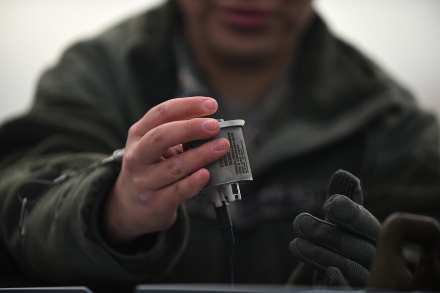 U.S. Air Force Senior Airman Mitzy Garcia, 7th Munitions Squadron munitions specialist, places a fuse initiator in a guided bomb unit at Royal Air Force Fairford, U.K. The 7th MUNS plays a key role in B-1B Lancer training and mission readiness by storing, maintaining and delivering quality munitions, and maintaining munitions release systems. (U.S. Air Force photo by Airman 1st Class Emily Copeland)