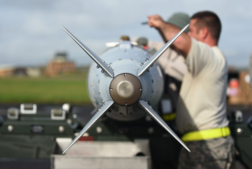 U.S. Air Force Airmen assigned to the 7th Munitions Squadron at Dyess Air Force Base, Texas, complete and inspect a guided bomb unit at RAF Fairford, U.K. The 7th MUNS participated in real-time training for various B-1B Lancer exercises in Europe in support of the U.S. Air Forces in Europe. (U.S. Air Force photo by Airman 1st Class Emily Copeland)