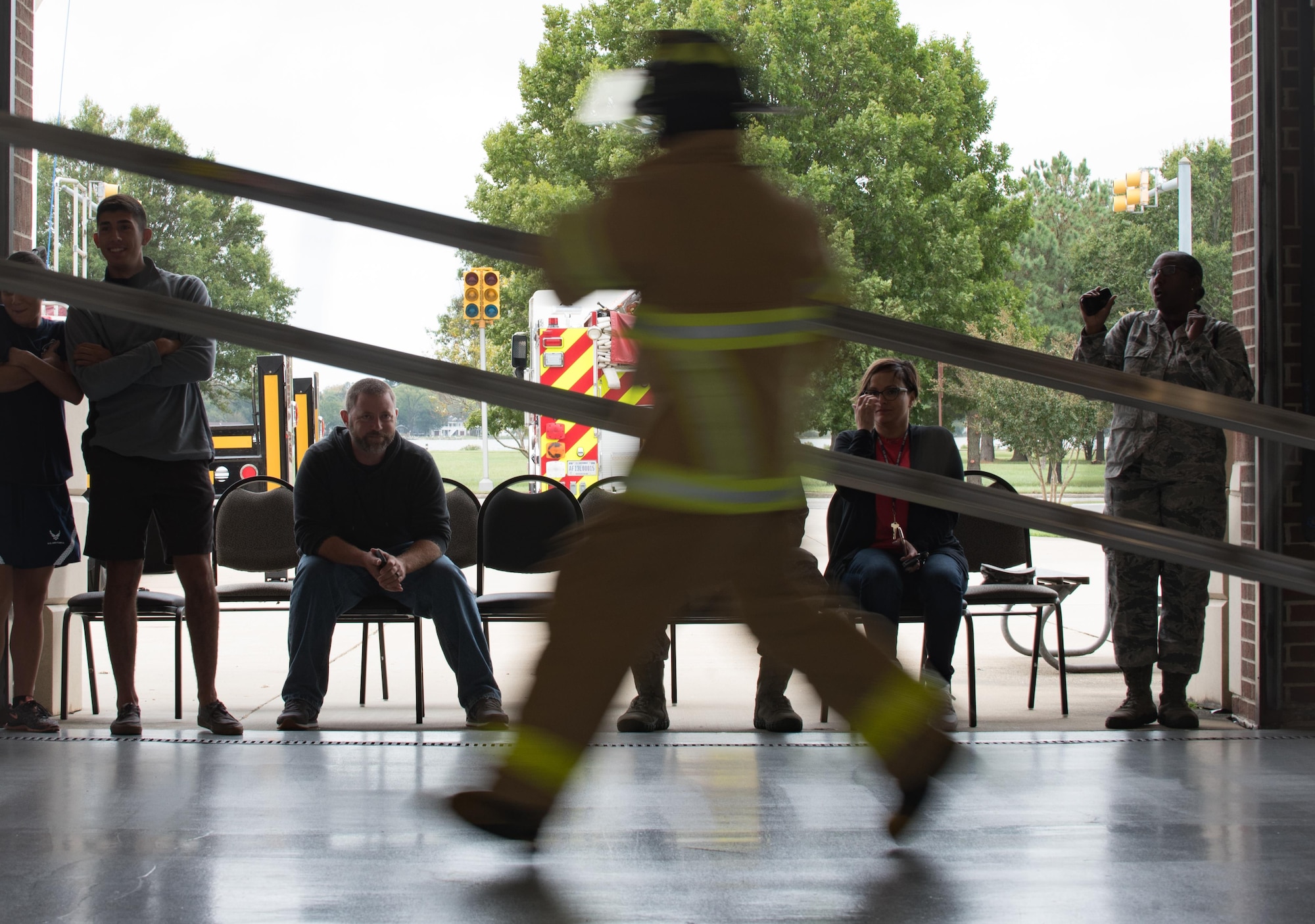 A participant competes in the ladder carry obstacle during the Firefighter Combat Challenge at Joint Base Langley-Eustis, Va., Oct. 13, 2017.